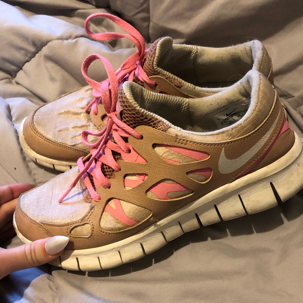 Worn pink & gold Nike shoes